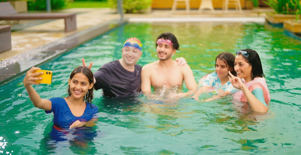 A diverse group of people enjoying a sunny day in a swimming pool splashing water and relaxing together