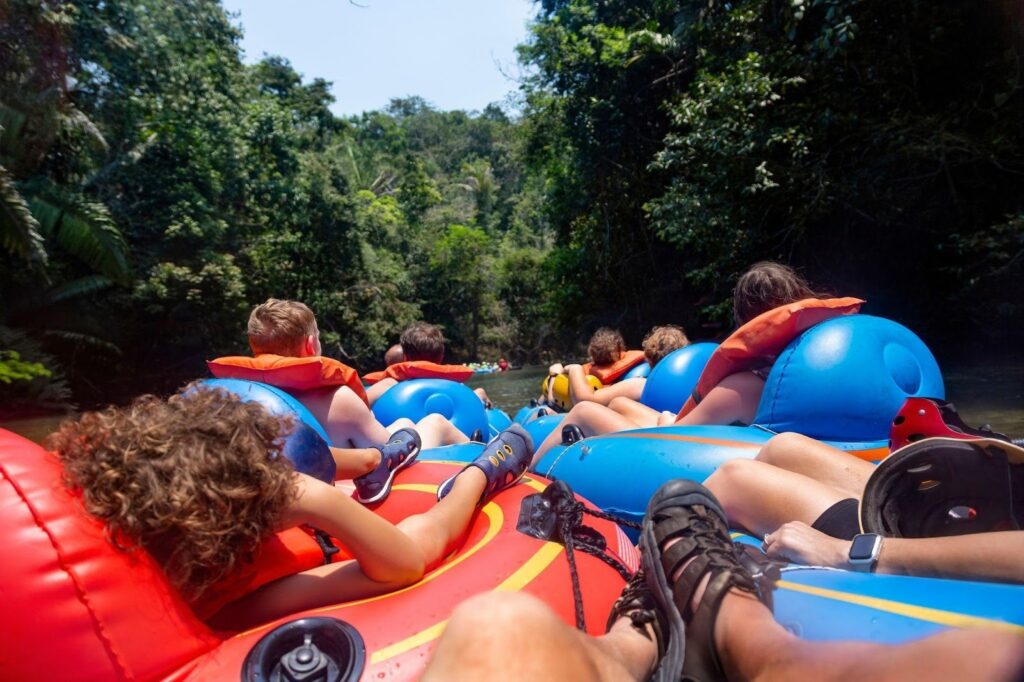 A group of people enjoying a sunny day on an inflatable raft floating on calm water